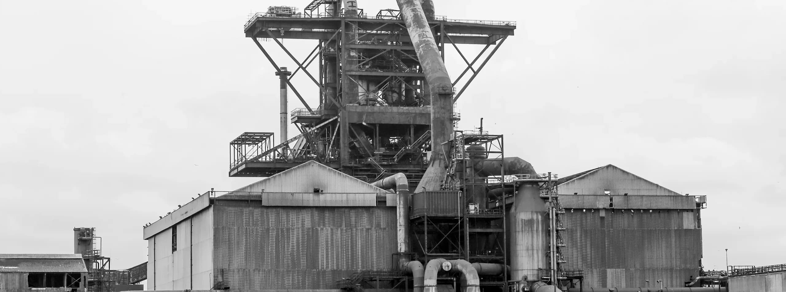 Wide black-and-white view of a British Steel shutdown scene — process plant infrastructure prepared for refractory works during an outage