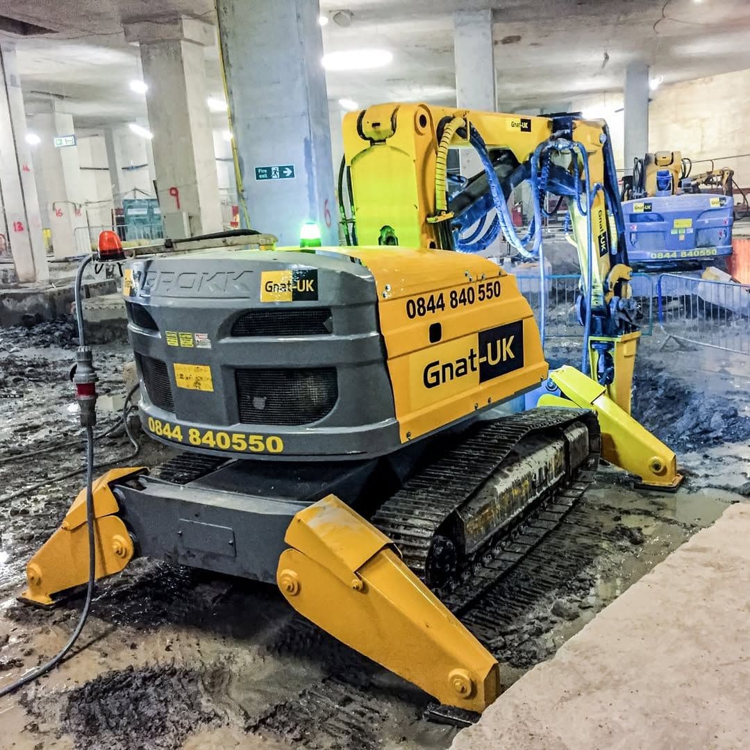 Pair of Brokk 800 demolition robots with Atlas Copco hydraulic peckers tackling reinforced concrete foundations