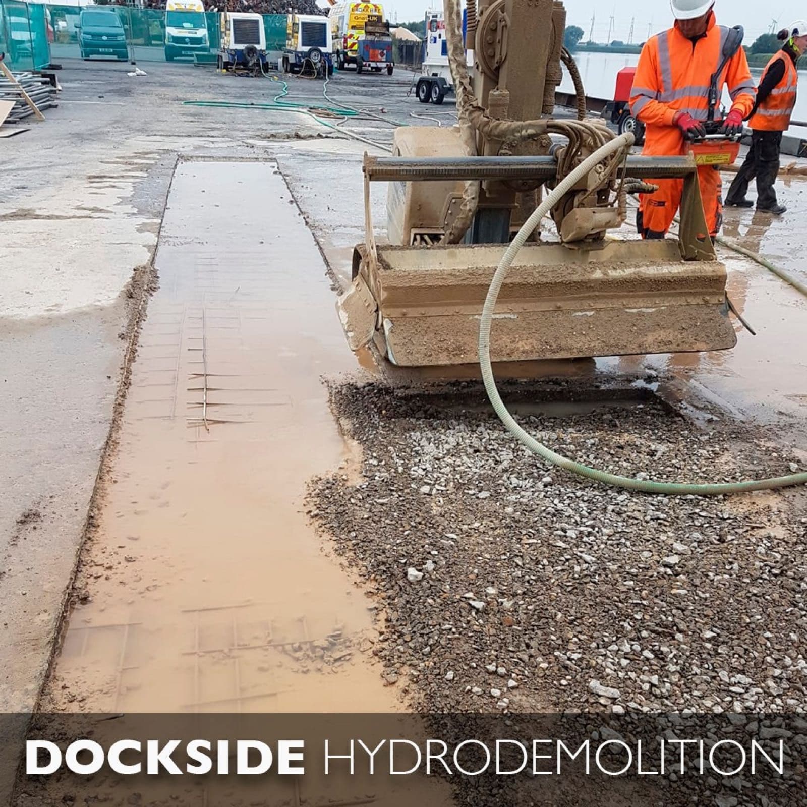 Aquajet hydrodemolition robot with boom extension removing concrete from a coastal jetty deck