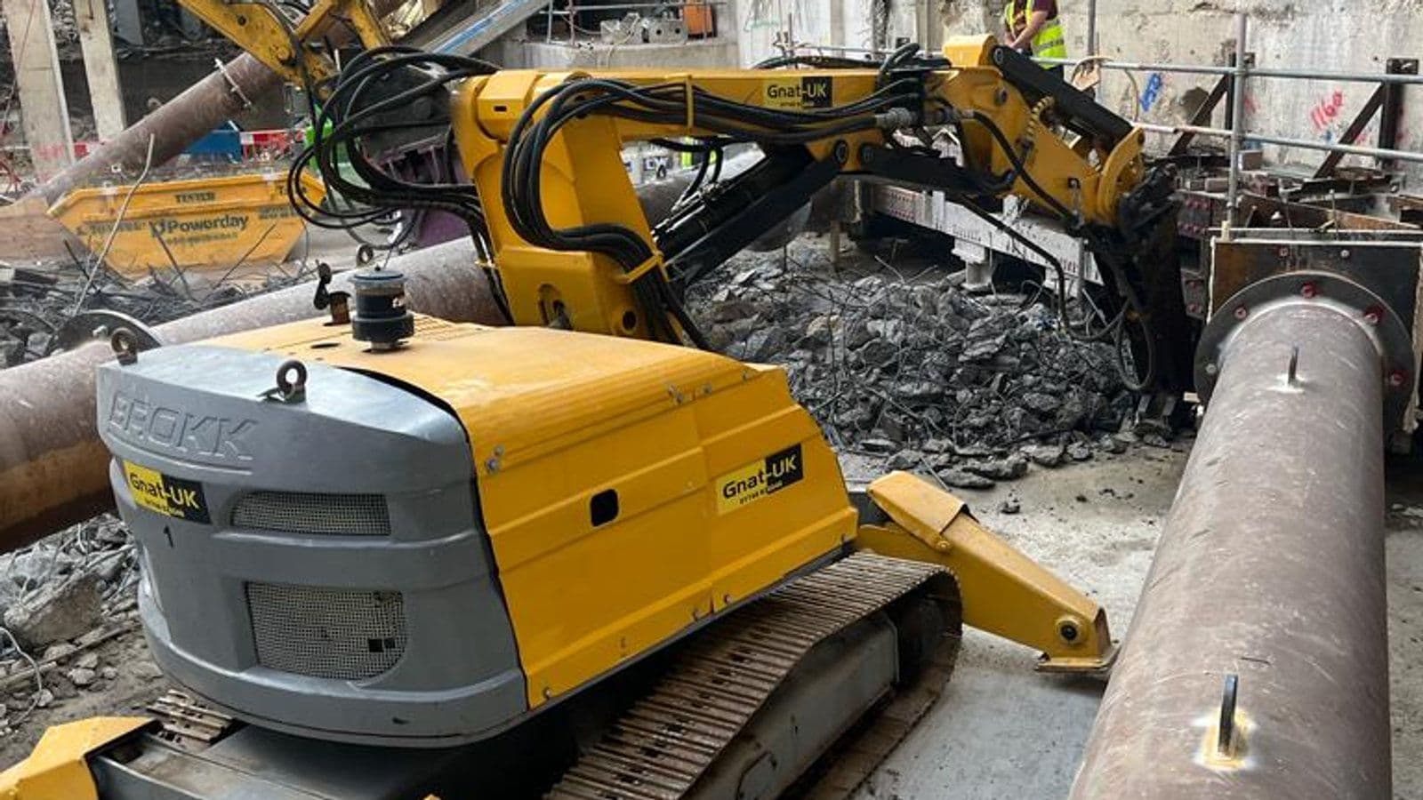 Two Brokk 800 demolition robots breaking out reinforced concrete foundations in a basement