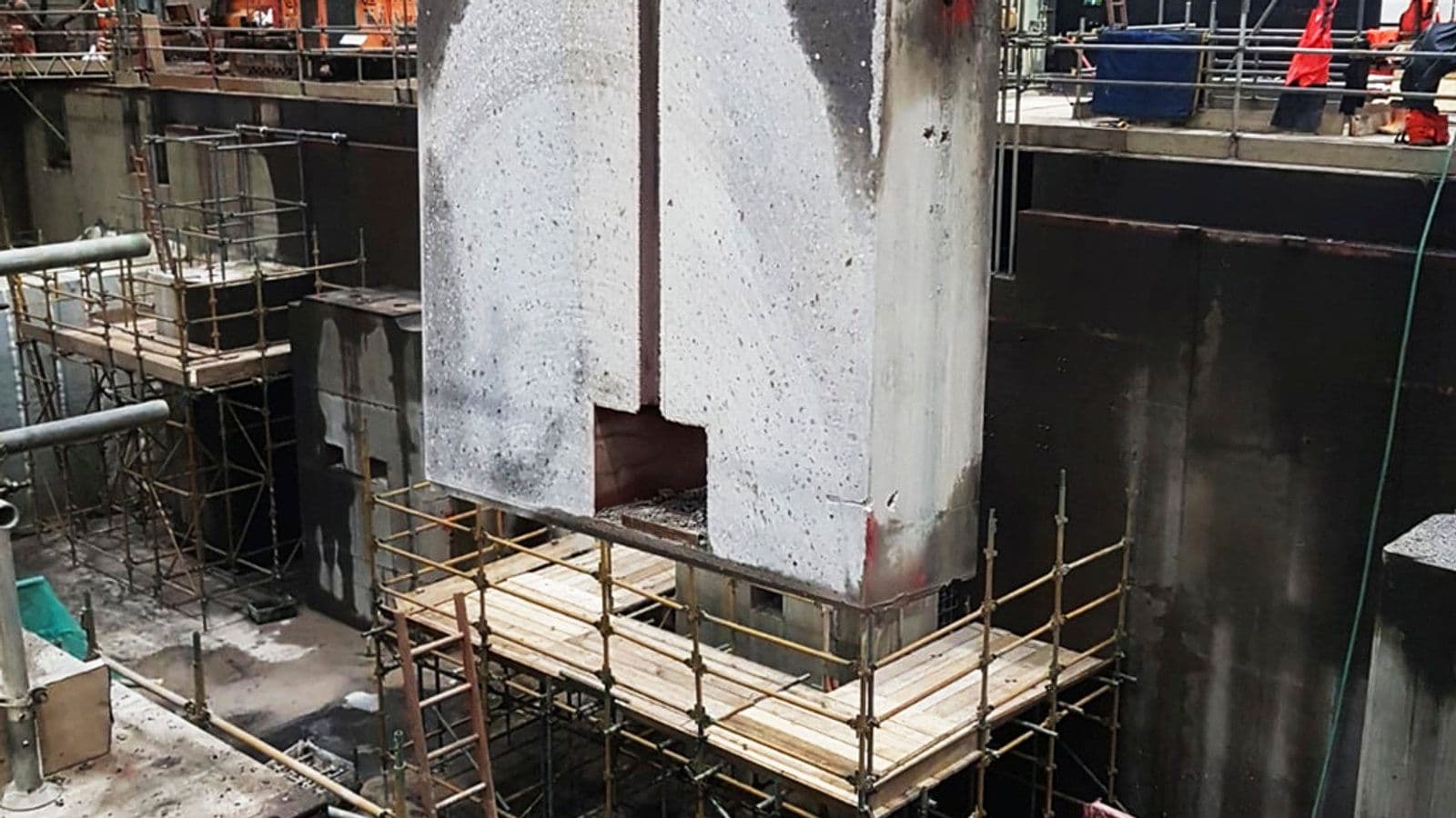 Aquajet hydrodemolition robot and Hilti diamond wire saw working on concrete plinths in a car factory floor